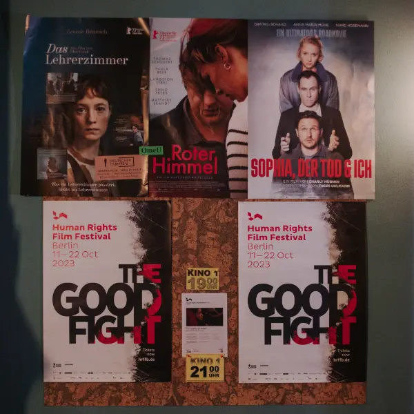 Five different film posters arranged on a wall.