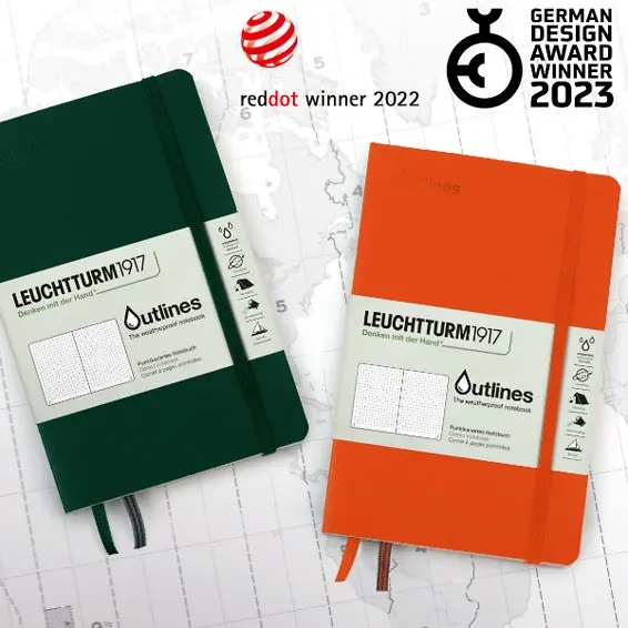 leuchtturm1917_outlines_mit_reddot_award_2022__german_design_award_winner Two notebooks in dark green and orange with elastic band, product label, two design awards, map background.