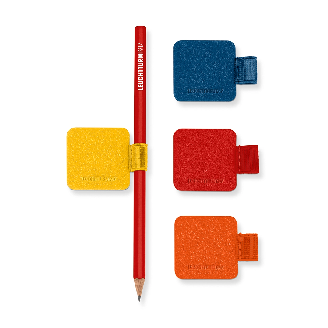 Leuchtturm1917 Penloop Sortiment in den neuen Farben 2026. Red pencil in a yellow pencil holder, next to square pencil holders in blue, yellow, red and orange.