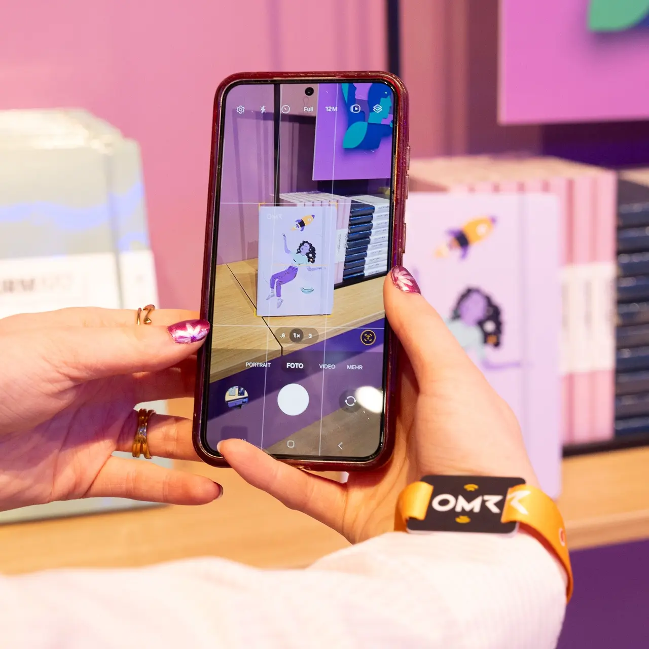 Person photographs a notebook display with a smartphone at close range.