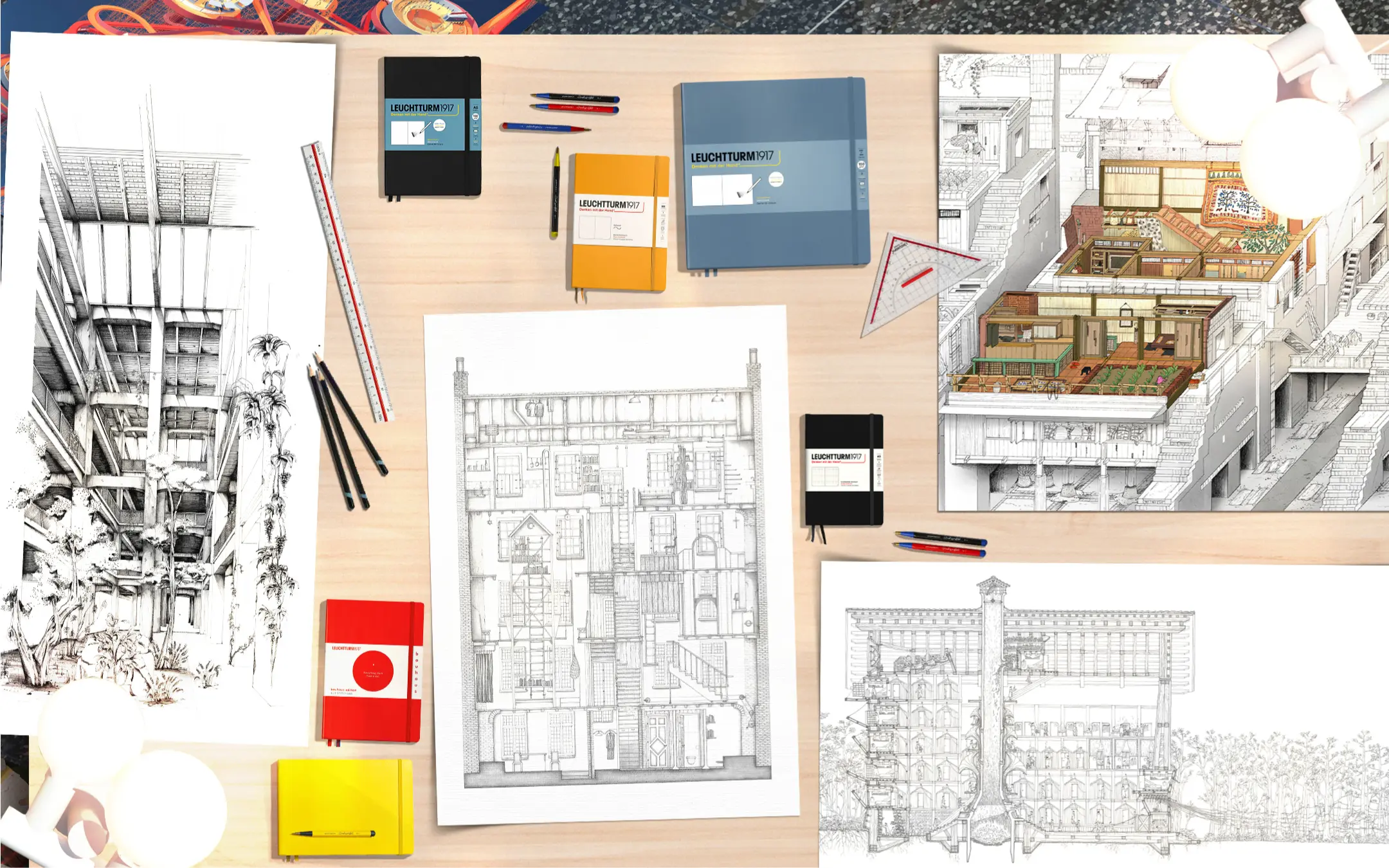 Architekturzeichnungen mit Leuchtturm1917 Notizbüchern Desk flatlay with architectural drawings, LEUCHTTURM1917 notebooks and writing tools.