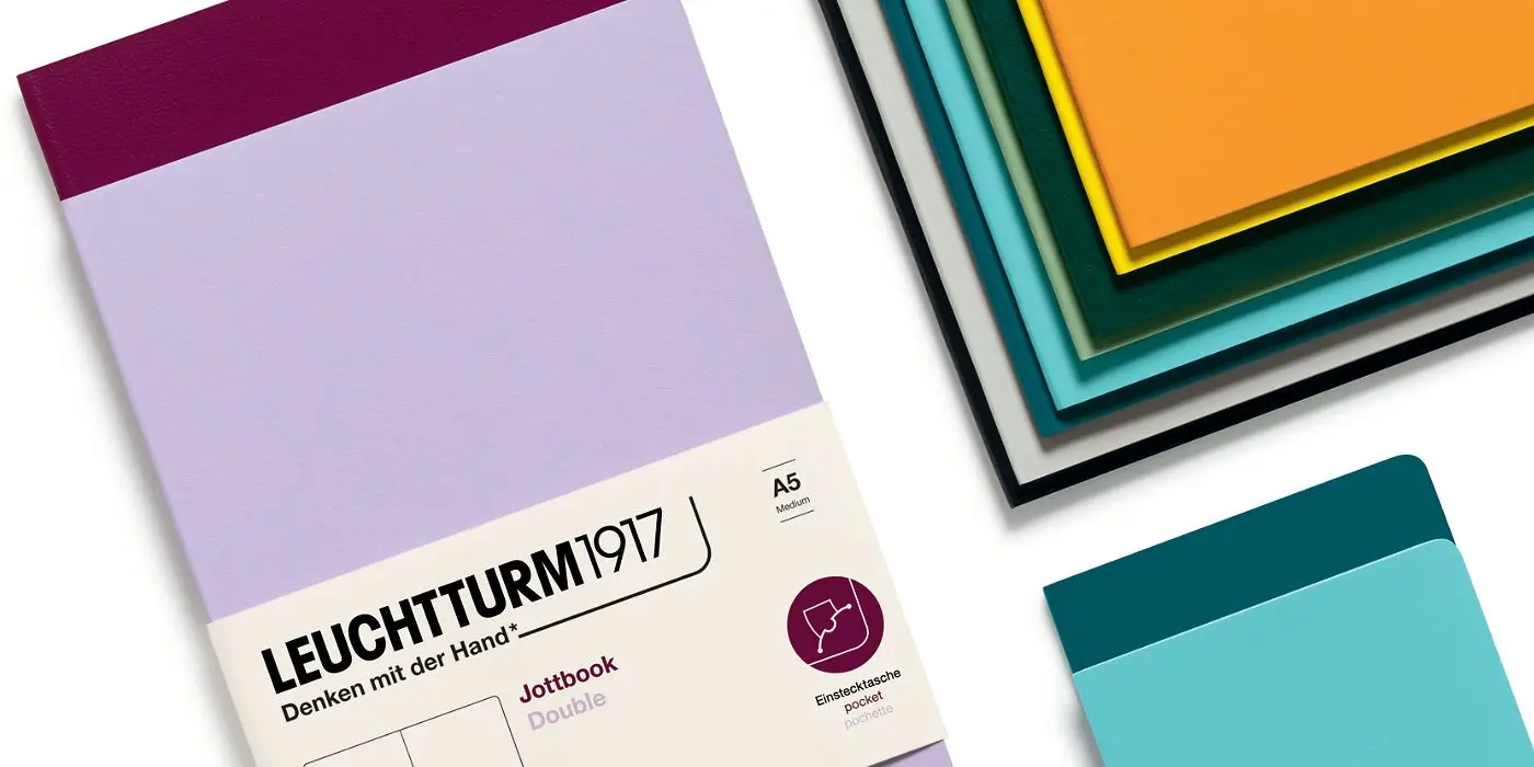 jottbook_double_header_1400x700 Lilac A5 notebook next to notebooks in burgundy, green, turquoise, yellow, black and other colors.