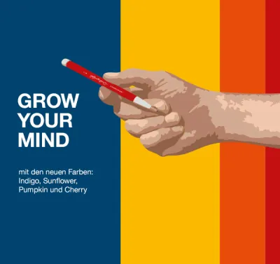 Hand holding ballpoint pen in front of blue, yellow, orange and red colour blocks, GROW YOUR MIND text.